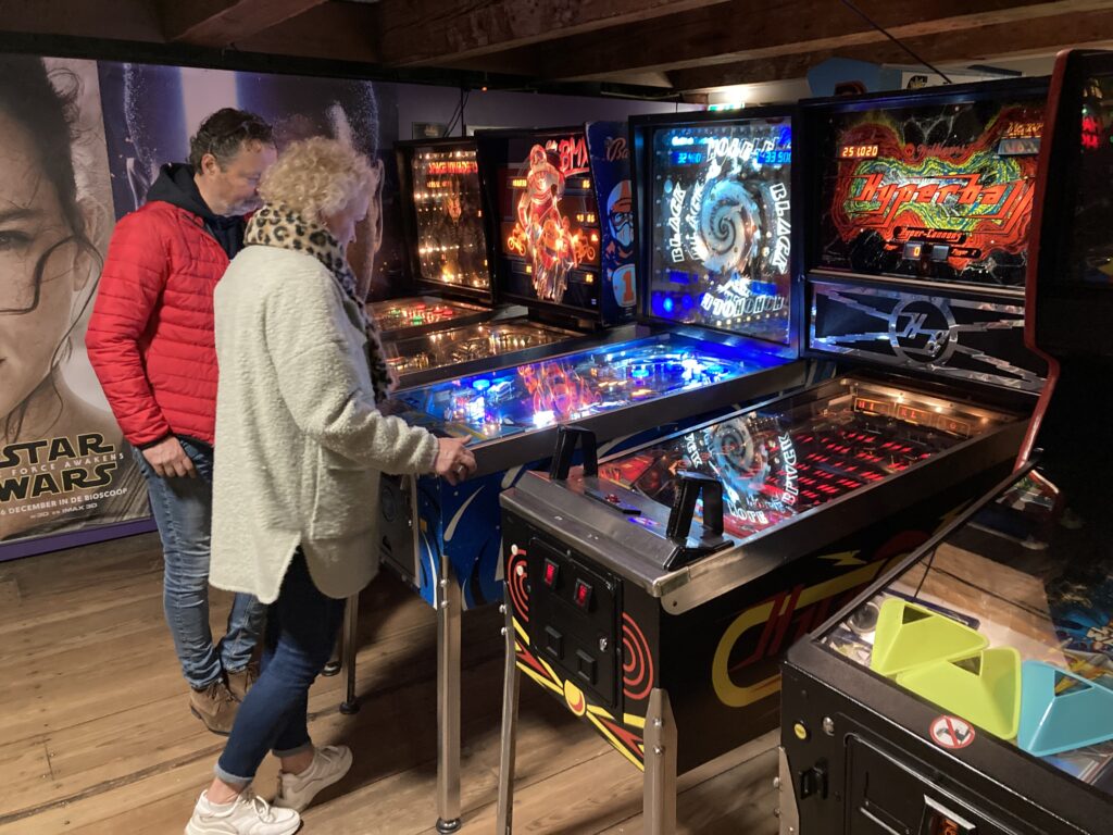 A couple playing early 80ies pinball machines