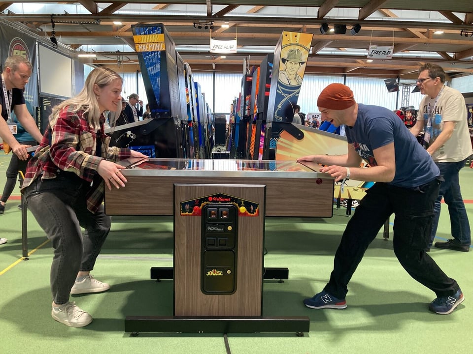 Visitors at EPC playing a 2-player pinball game.
